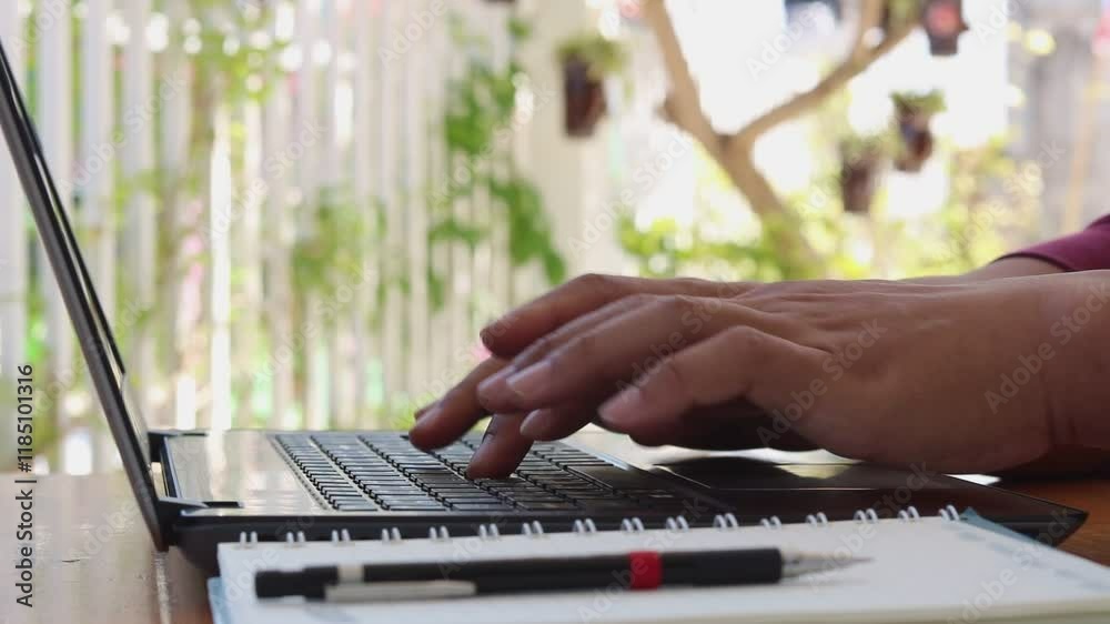 Poster close up of hand typing password on the computer laptop keyboard, on wooden desk.