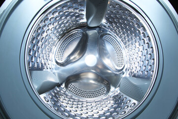 Washing machine with empty drum as background, closeup