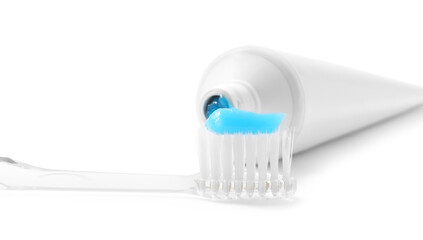 Toothbrush with toothpaste and tube isolated on white