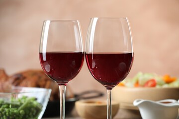 Red wine and delicious dinner served on table, closeup