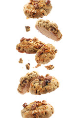 Yummy nut cookies in air on white background