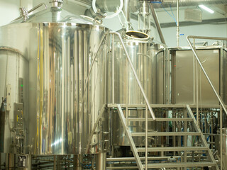 A small industry brewery's brewing tanks in a brewery that produces craft beer