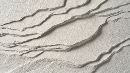 A textured surface featuring flowing, wave-like patterns, evoking a sense of movement and depth in a neutral color palette.