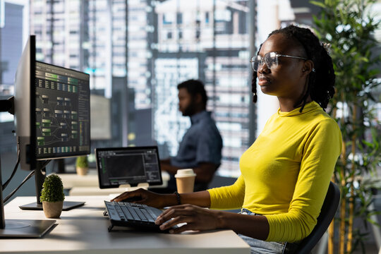 Machine learning infrastructure engineer designing and developing algorithms that enable machines to learn from data. Woman in office training and deploying large scale deep learning models