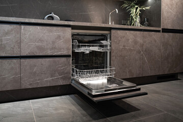 Integrated dishwasher with open door in modern gray kitchen cabinet.