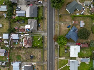 High-angle view of residential street with various homes and yards. Different architectural styles and property sizes. MURUPARA, MURUPARA, BAY OF PLENTY, NEW ZEALAND