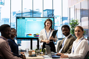 Employees team analyzing infographics to offer solutions for the new project, looking to finish tasks before deadline. Enterprise coworkers attending problem solving conference in boardroom.