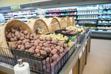 Potatoes and other vegetables on the supermarket counter.