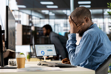 Corporate black CEO experiences job pressure at the office, feeling overwhelmed and stressed by...