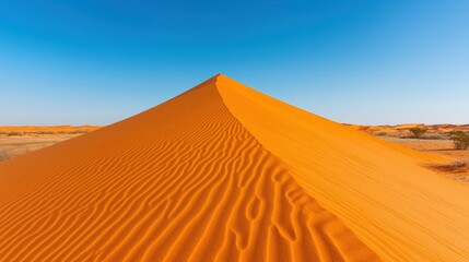 Wilderness and desert pristine, A vast and serene desert landscape featuring a prominent sand dune under a clear blue sky, highlighting the textures of the golden sand.