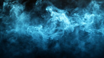 Fototapeta premium Blue smoke filling the black background creating abstract shapes