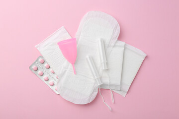 Flat lay composition with menstrual products on pink background