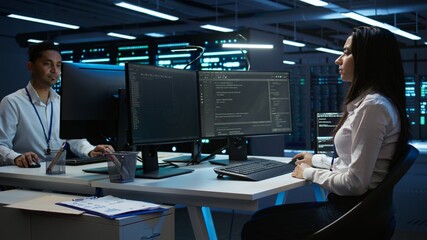 Team of technicians in data center designing, implementing and managing infrastructure to ensure...