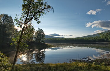 Russia, Western Buryatia. Early morning on the deserted taiga lake Guzen-Nur, hidden from prying...