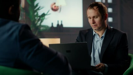 African american secret service agent in a classy headquarters library, briefing each other on critical mission case details over whiskey glasses. Professional intelligence bureau spies. Camera B.