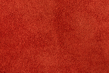 Suede in a warm shade of red as a background.