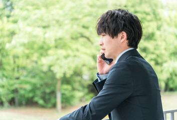 スマホで電話・通話・会話するビジネスマン（怒る・パワハラ・ストレス）
