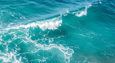 Pure blue turquoise water texture of the ocean sea with foam from and waves
