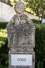 Fototapeta premium Stone statue depicting the fire belonging to the episcopal garden of the city of Castelo Branco-Portugal.