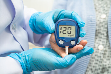 Doctor use digital glucose monitor measure and test stripe for check diabetes from finger blood sugar level.