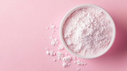 a bowl of powder on a pink surface