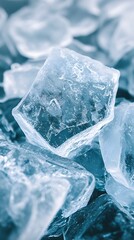Obraz premium Close-up of clear ice cubes on a blue background, creating a refreshing feel.