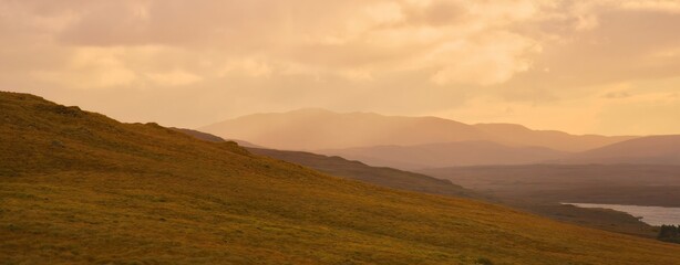Glenveagh National Park in Donegal Ireland -Spectacular aerial view showcasing lush green valleys and rolling hills beneath a colorful and vibrant sky