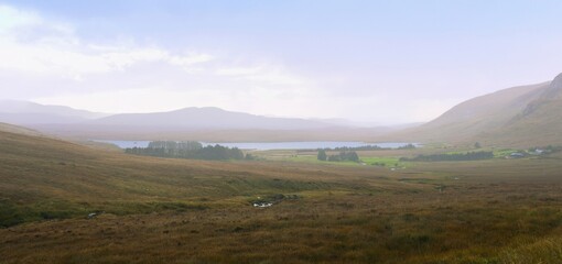Glenveagh National Park in Donegal Ireland -Spectacular aerial view showcasing lush green valleys and rolling hills beneath a colorful and vibrant sky