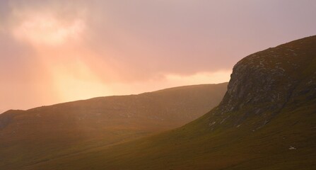 Glenveagh National Park in Donegal Ireland -Spectacular aerial view showcasing lush green valleys and rolling hills beneath a colorful and vibrant sky