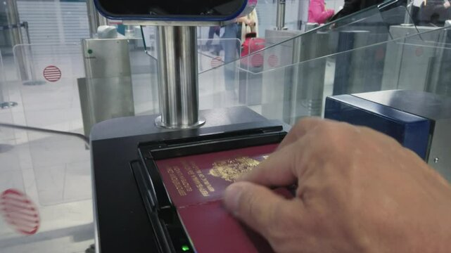 Hand scanning passport at an automated airport security checkpoint