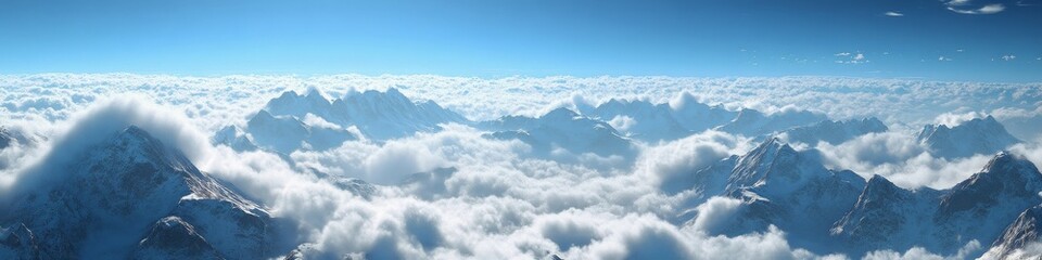 Fototapeta premium A breathtaking panoramic view of snow-capped mountains above the clouds.