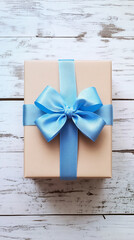 gift box with blue bow over white wooden table