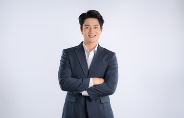 Portrait of young Asian business man posing on white background