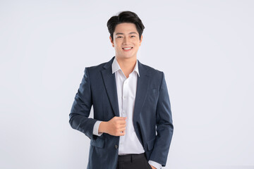 Portrait of young Asian business man posing on white background