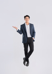 Full body image of a young Asian business man posing on a white background