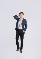 Full body image of a young Asian business man posing on a white background