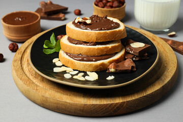Bread with chocolate paste in a bowl on a gray background