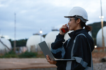 Inspection engineers working with laptops of gas refinery plant and refinery oil factory industry