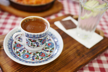 Turkish Coffee in Floral Cup on Checkered Tablecloth