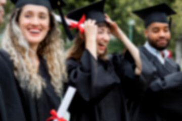Happy diverse students graduating university, celebrating with diplomas