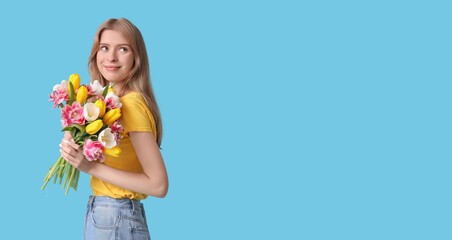 Pretty young girl holding bouquet of beautiful tulips on light blue background with space for text. Banner for International Women's Day