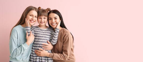 Happy lesbian couple and little adopted girl on pink background with space for text