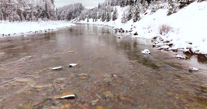 Winter Forest and River Aerial Drone Glacier National Park Montana