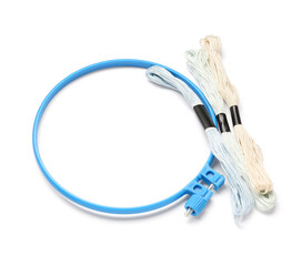 Plastic embroidery hoop with different mouline threads isolated on white background