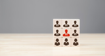 A cube displaying various silhouettes of professionals, with one figure highlighted in red, symbolizing uniqueness or standout qualities in a corporate context.