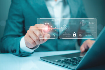 A businessman interacts with a digital interface, showcasing technology, data security, and innovation while using a laptop.