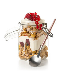 Jar of tasty granola with yogurt on white background