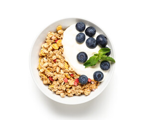 Bowl of tasty granola with yogurt on white background, closeup