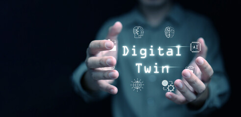 Digital twin concept.  Industrial manufacturing automation technology. A man with digital twin icons in his hands.