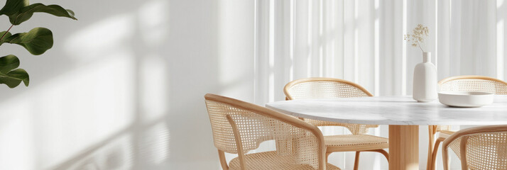 Modern dining room with round marble table and rattan chairs, featuring soft natural light and minimalist aesthetic